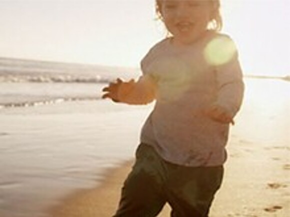 baby on sandy beach near the sea