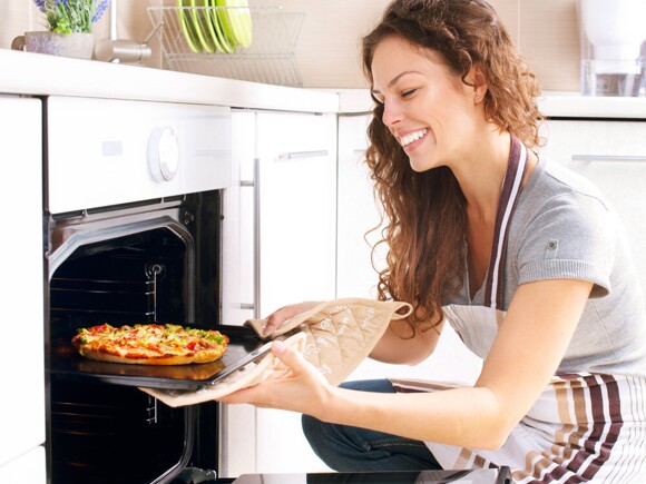 Woman cooking pizza