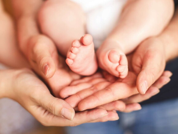 Baby feet in parents hand