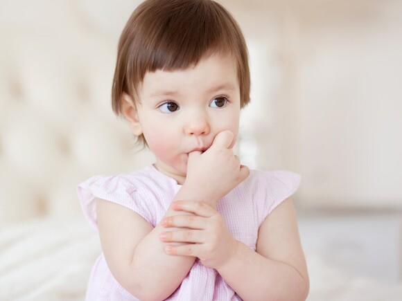 Baby girl sucking thumb
