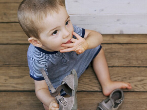 Baby boy biting nail