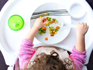 kid eating food with fork