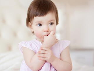 Baby girl sucking thumb