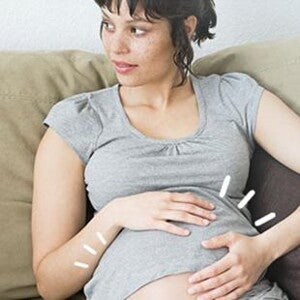 Pregnant woman sitting on sofa