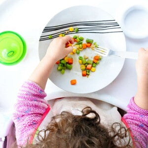 kid eating food with fork