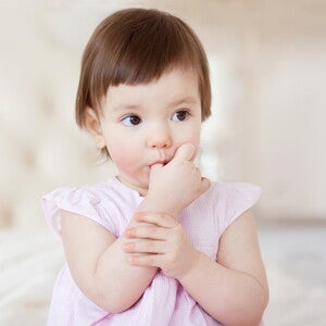 Baby girl sucking thumb