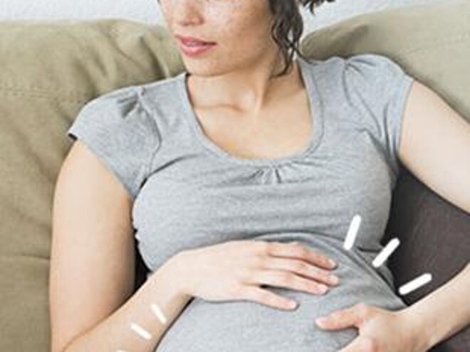 Pregnant woman sitting on sofa Pregnant woman sitting on sofa